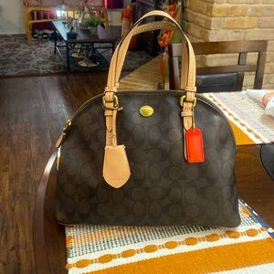 Coach bag. Leather trim on handles and in the bottom of bag.